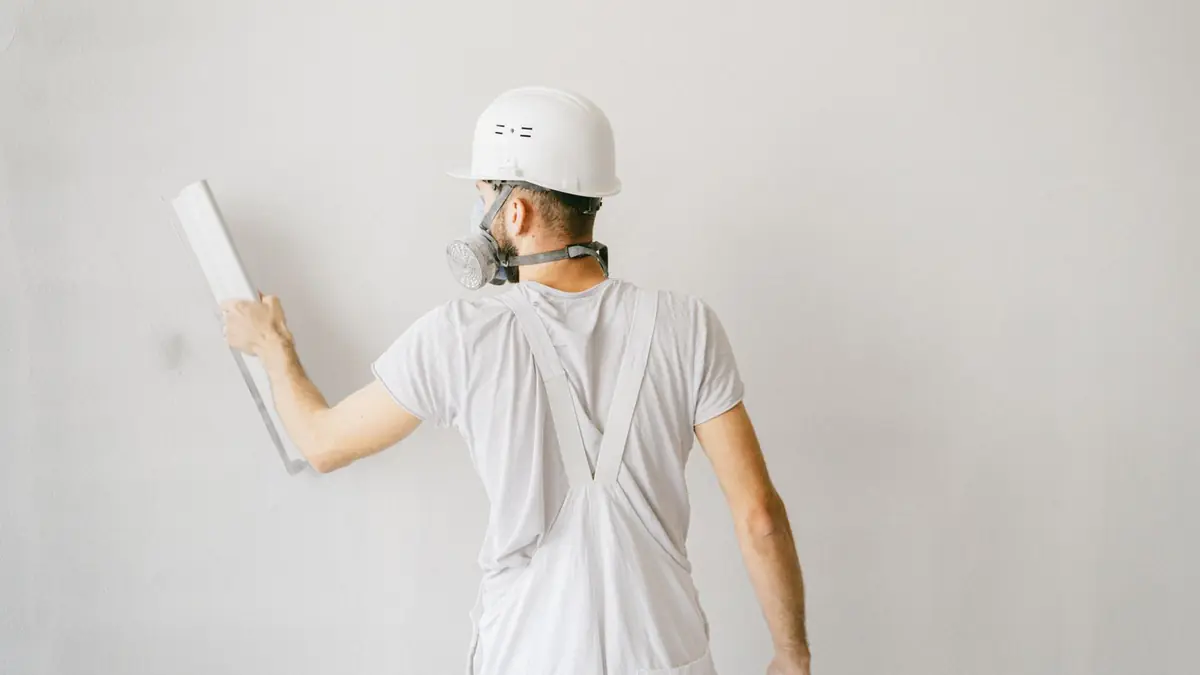 A worker applying texture to a wall